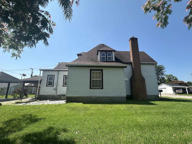 448 N 7th St, Mitchell, IN 47446 - back of property featuring a chimney, a yard, and a shingled roof