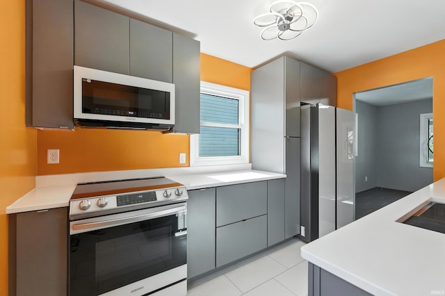 1914 Emerson Ave, Fort Wayne, IN 46808 - kitchen with appliances with stainless steel finishes, gray cabinets, light countertops, and light tile patterned flooring