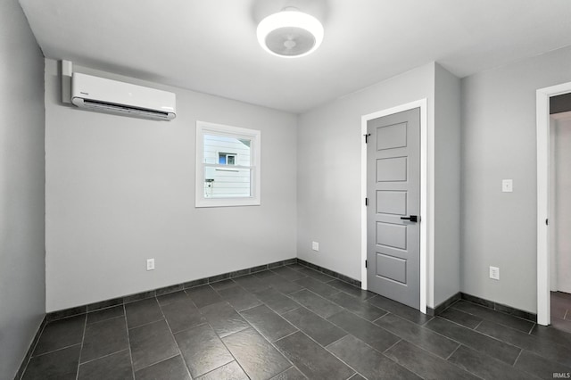 1914 Emerson Ave, Fort Wayne, IN 46808 - empty room featuring a wall unit AC and dark tile patterned flooring
