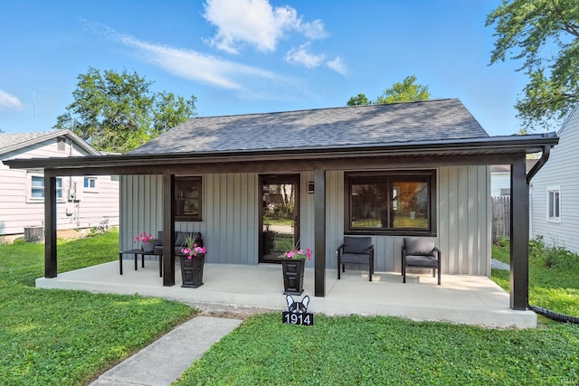 1914 Emerson Ave, Fort Wayne, IN 46808 - rear view of property featuring a porch, a yard, and a shingled roof