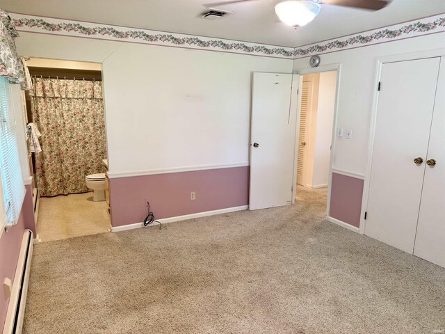3105 Perrysburg Rd, Logansport, IN 46947 - unfurnished bedroom featuring baseboard heating, carpet floors, ensuite bath, and a closet