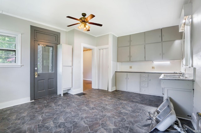 1331 Summit St, New Haven, IN 46774 - kitchen featuring gray cabinetry, dark stone finish flooring, ceiling fan, crown molding, and light countertops