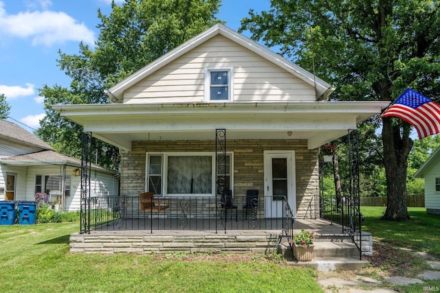 1331 Summit St, New Haven, IN 46774 - view of front of house with a porch, a front lawn, and stone siding