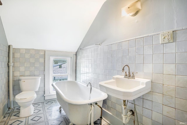 1331 Summit St, New Haven, IN 46774 - bathroom with tile walls, a freestanding bath, and vaulted ceiling