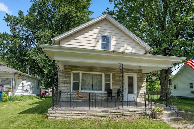1331 Summit St, New Haven, IN 46774 - view of front of home featuring a porch, a front lawn, and stone siding