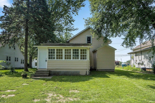 1331 Summit St, New Haven, IN 46774 - rear view of property featuring a lawn and entry steps