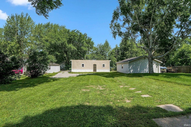1331 Summit St, New Haven, IN 46774 - view of grassy yard with an outbuilding and view of wooded area