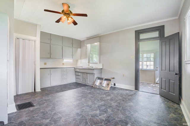 1331 Summit St, New Haven, IN 46774 - kitchen featuring gray cabinetry, ceiling fan, dark stone finish floors, light countertops, and ornamental molding