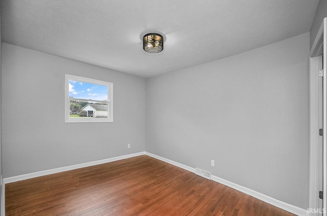 58155 Beehler Rd, Osceola, IN 46561 - empty room with dark wood-style flooring and a textured ceiling