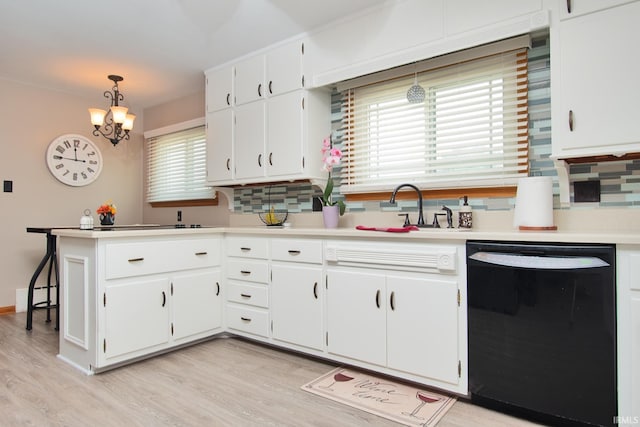 1401 S M St, Elwood, IN 46036 - kitchen with black dishwasher, light wood-style floors, white cabinetry, and light countertops