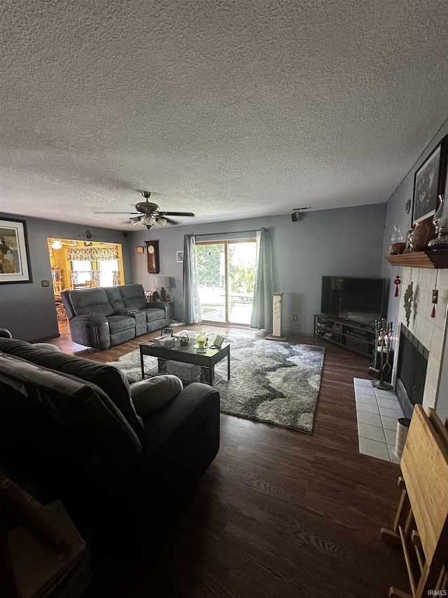 619 Briarfield Dr, Fort Wayne, IN 46825 - living area with wood finished floors, a tile fireplace, a ceiling fan, and a textured ceiling