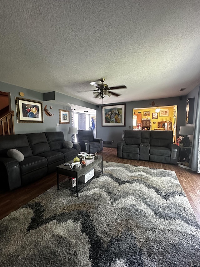 619 Briarfield Dr, Fort Wayne, IN 46825 - living area featuring wood finished floors, a ceiling fan, and a textured ceiling
