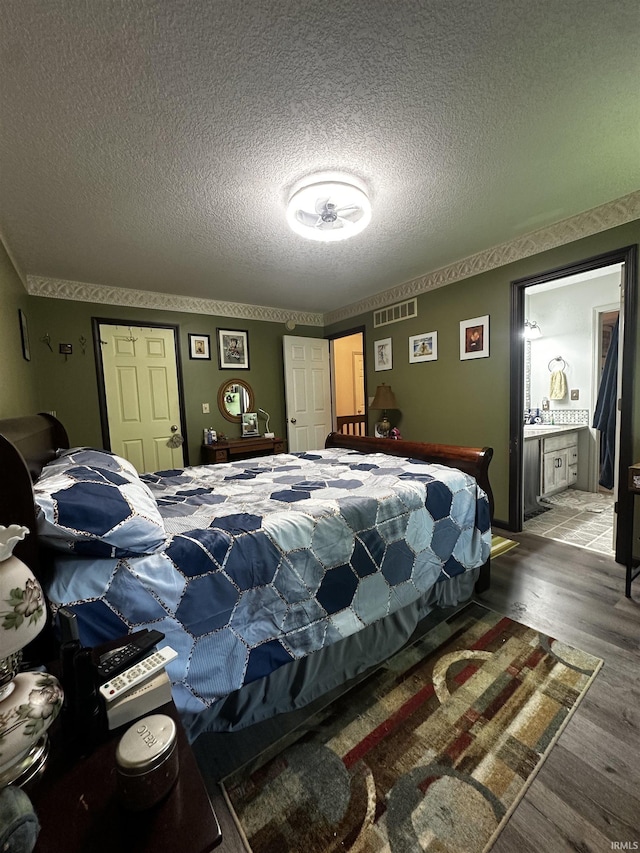 619 Briarfield Dr, Fort Wayne, IN 46825 - bedroom featuring wood finished floors, a textured ceiling, and a closet