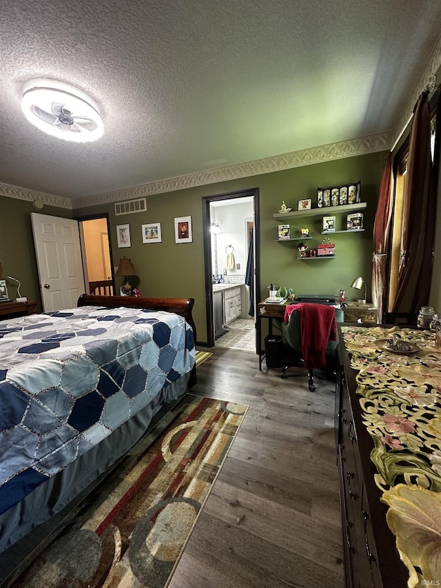 619 Briarfield Dr, Fort Wayne, IN 46825 - bedroom with a textured ceiling, wood finished floors, and ensuite bathroom