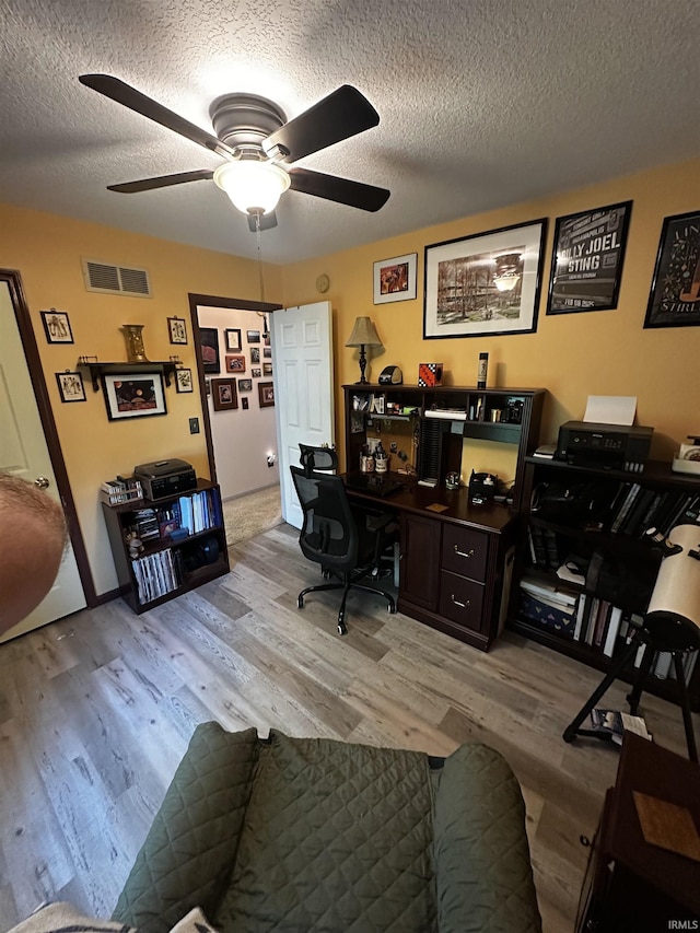 619 Briarfield Dr, Fort Wayne, IN 46825 - home office with ceiling fan, light wood-style floors, and a textured ceiling