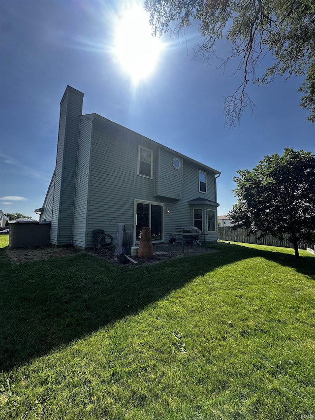 619 Briarfield Dr, Fort Wayne, IN 46825 - rear view of house featuring a chimney and a patio