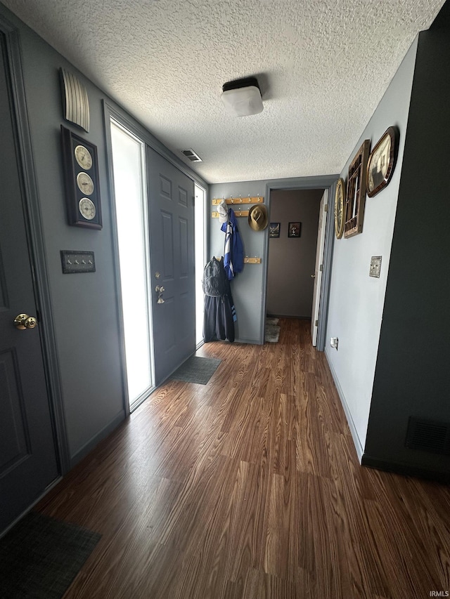 619 Briarfield Dr, Fort Wayne, IN 46825 - foyer entrance featuring wood finished floors and a textured ceiling