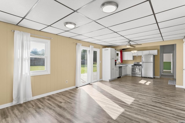51278 Arch St, Granger, IN 46530 - unfurnished living room featuring wood finished floors, a drop ceiling, and a ceiling fan