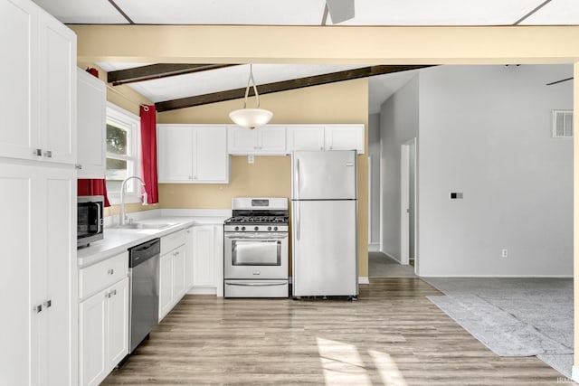 51278 Arch St, Granger, IN 46530 - kitchen with appliances with stainless steel finishes, white cabinets, light countertops, and light wood-style flooring