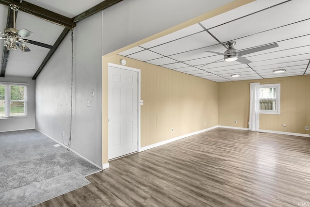 51278 Arch St, Granger, IN 46530 - spare room with a ceiling fan, wood finished floors, healthy amount of natural light, beamed ceiling, and wood walls