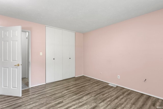 51278 Arch St, Granger, IN 46530 - unfurnished bedroom with wood finished floors and a closet