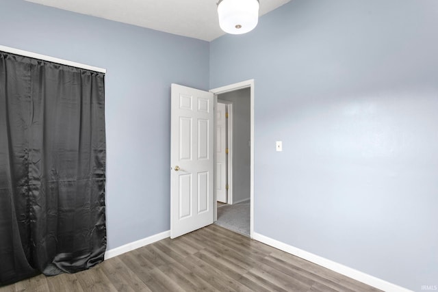 51278 Arch St, Granger, IN 46530 - unfurnished bedroom with wood finished floors and baseboards