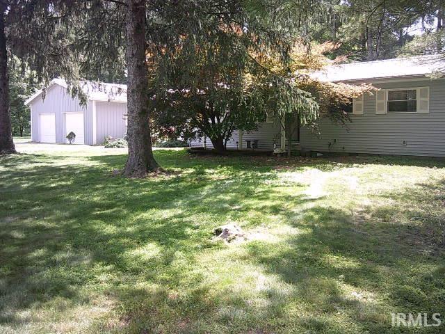 1060 Trinton Cir, Bedford, IN 47421 - view of green lawn with a garage and an outdoor structure