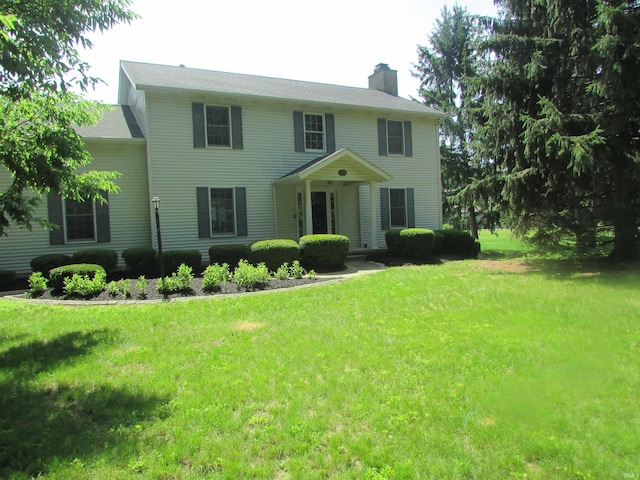 4109 E Woodland Ct, Leesburg, IN 46538 - colonial inspired home featuring a chimney and a front lawn