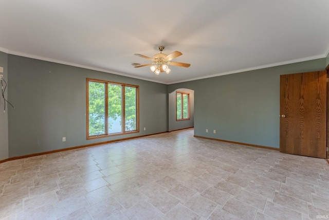 425 E Val Ln, Marion, IN 46952 - spare room featuring ceiling fan, ornamental molding, arched walkways, and light stone finish flooring