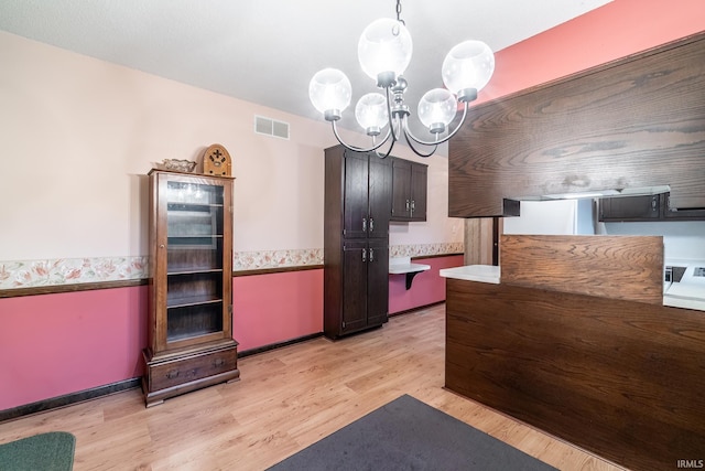 9246 Fritz Rd, Fort Wayne, IN 46818 - kitchen with a chandelier, light wood-type flooring, and light countertops