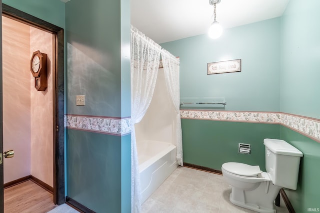 9246 Fritz Rd, Fort Wayne, IN 46818 - bathroom featuring shower / bath combo with shower curtain and wainscoting