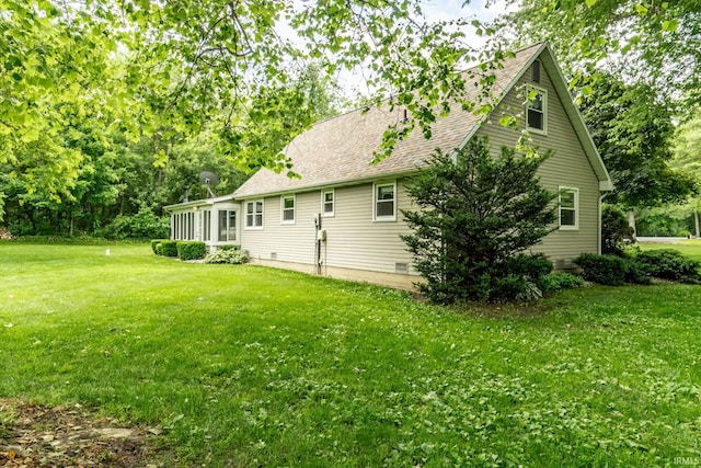 9246 Fritz Rd, Fort Wayne, IN 46818 - back of property with a lawn, a sunroom, and a shingled roof