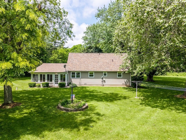 9246 Fritz Rd, Fort Wayne, IN 46818 - rear view of house featuring a yard, a sunroom, and a shingled roof