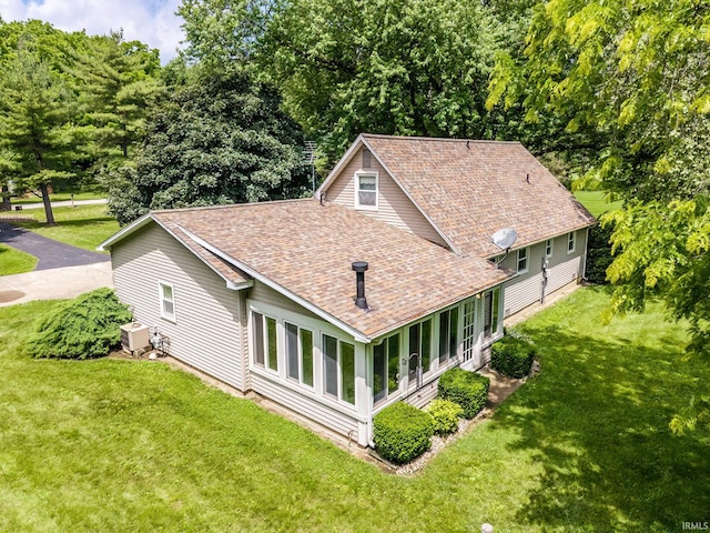 9246 Fritz Rd, Fort Wayne, IN 46818 - rear view of house with a shingled roof and a yard