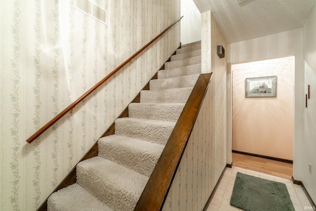9246 Fritz Rd, Fort Wayne, IN 46818 - stairs with tile patterned flooring and a textured ceiling