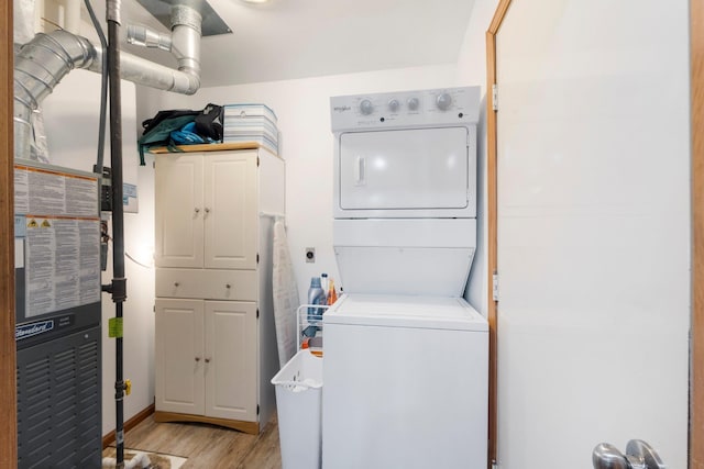 3139 E Colony Ave, Columbia City, IN 46725 - laundry room with estacked washer and dryer, cabinet space, and light wood-style flooring