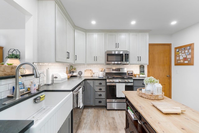 3139 E Colony Ave, Columbia City, IN 46725 - kitchen featuring stainless steel appliances, wood counters, tasteful backsplash, light wood-style flooring, and white cabinets
