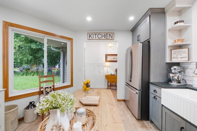 3139 E Colony Ave, Columbia City, IN 46725 - kitchen featuring freestanding refrigerator, open shelves, light wood-style flooring, gray cabinets, and dark countertops