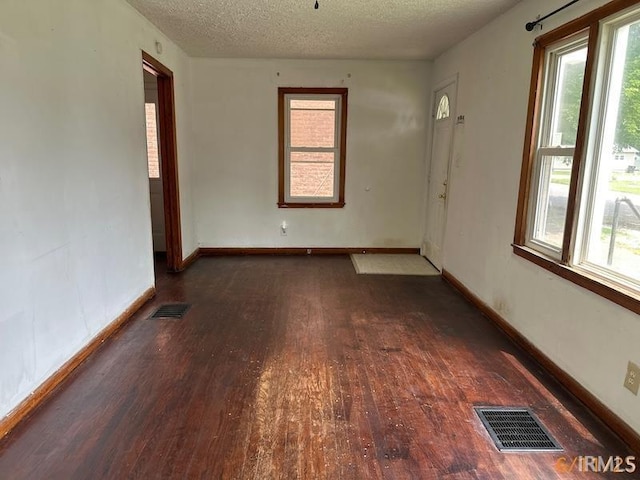 519 E Water St, Mount Vernon, IN 47620 - unfurnished room with wood-type flooring, a textured ceiling, and plenty of natural light