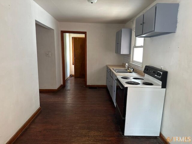 519 E Water St, Mount Vernon, IN 47620 - kitchen with electric stove, dark wood-type flooring, light countertops, and gray cabinets