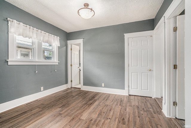 240 Bank St, Elkhart, IN 46516 - spare room with wood finished floors and a textured ceiling