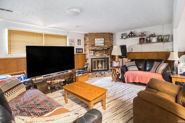 3301 Cabot Dr, South Bend, IN 46635 - living room with wooden walls, wainscoting, a textured ceiling, and a brick fireplace