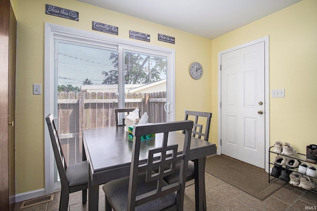 3301 Cabot Dr, South Bend, IN 46635 - dining space featuring dark tile patterned floors and baseboards