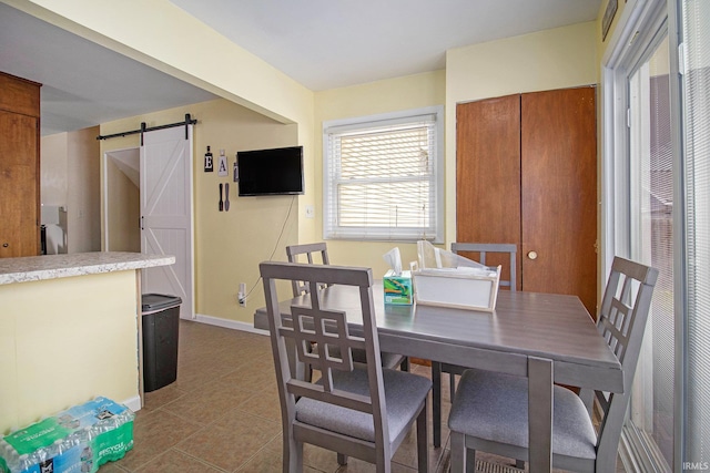 3301 Cabot Dr, South Bend, IN 46635 - tiled dining room with a barn door and baseboards