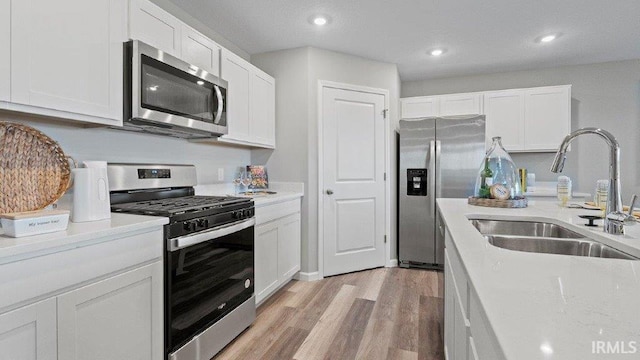 1185 Catesby Ct, Fort Wayne, IN 46818 - kitchen featuring stainless steel appliances, white cabinets, light wood-style flooring, and recessed lighting