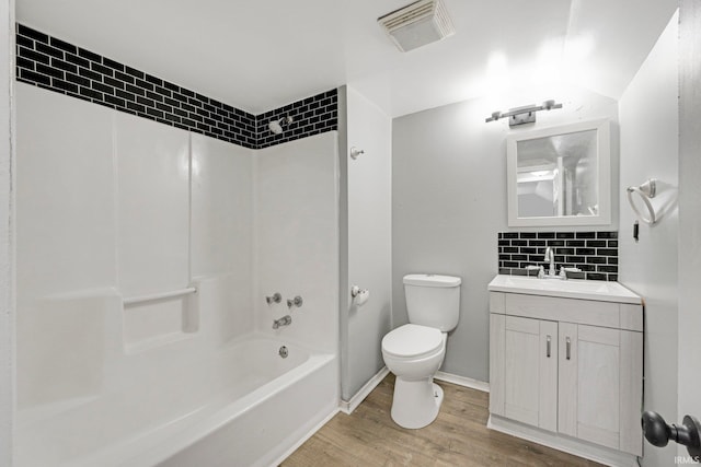 2725 Fox Ave, Fort Wayne, IN 46807 - full bath with vanity, wood finished floors, shower / tub combination, and tasteful backsplash
