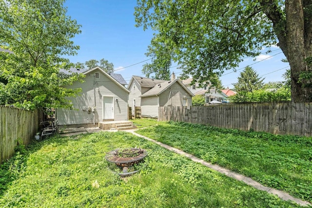 2725 Fox Ave, Fort Wayne, IN 46807 - fenced backyard featuring a fire pit and an outbuilding