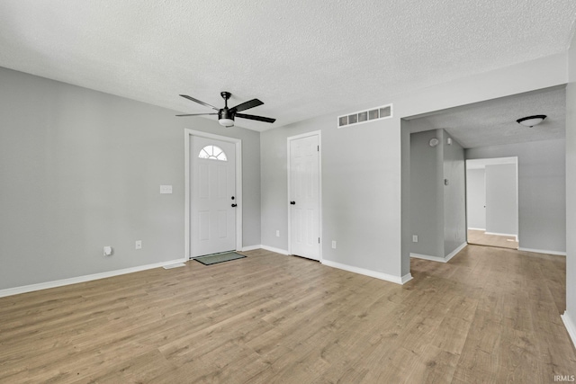 2725 Fox Ave, Fort Wayne, IN 46807 - entrance foyer with a textured ceiling, a ceiling fan, and light wood-style floors