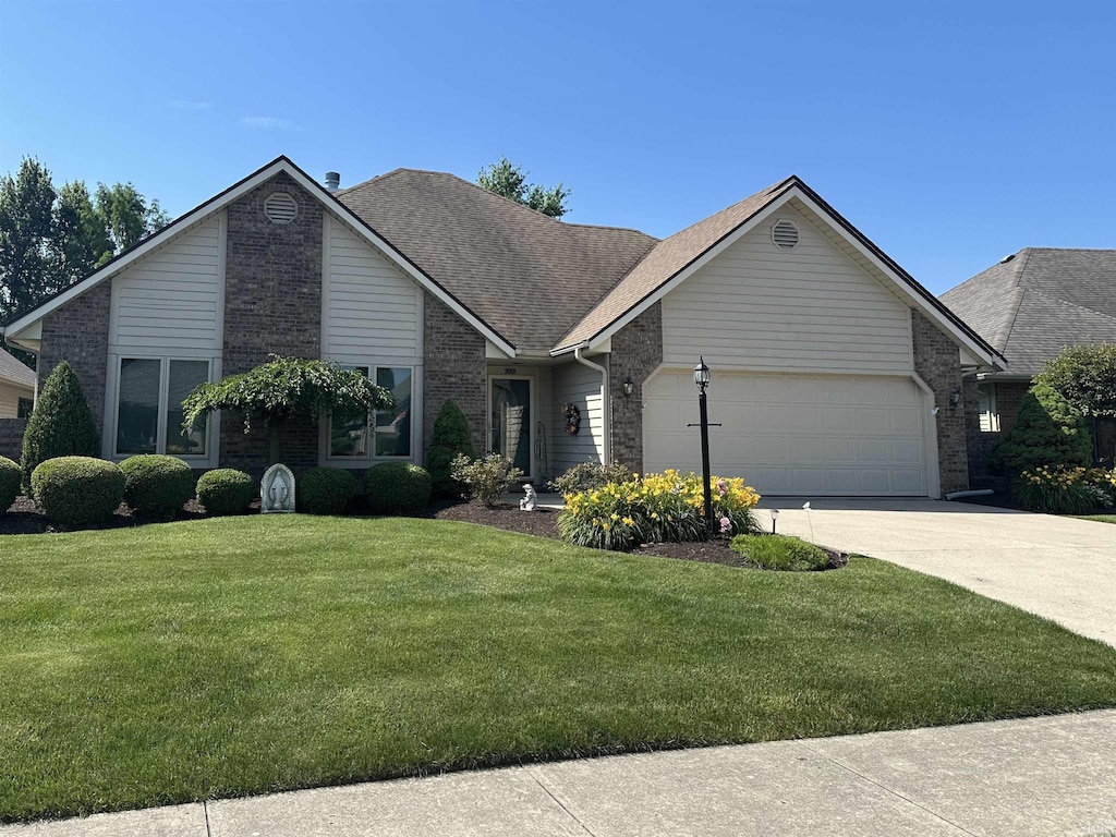 6420 Langley Ct, Fort Wayne, IN 46815 - view of front of house featuring an attached garage, brick siding, a front yard, concrete driveway, and a shingled roof