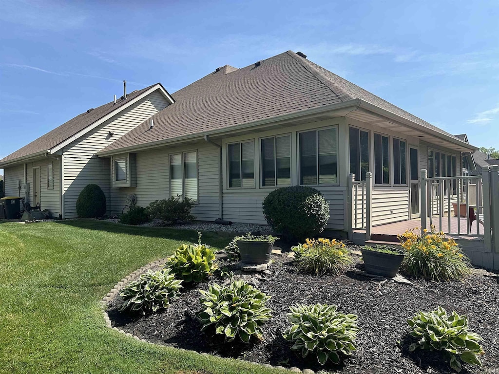 6420 Langley Ct, Fort Wayne, IN 46815 - view of side of home featuring a shingled roof, a yard, and a deck
